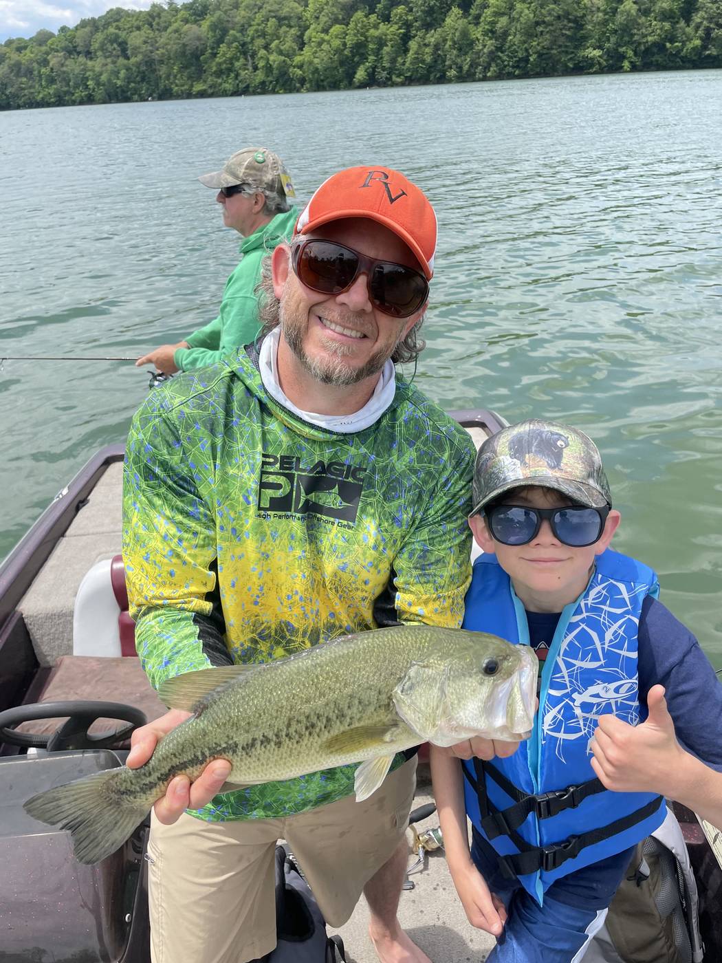 A solid largemouth bass, caught with a young angler aboard