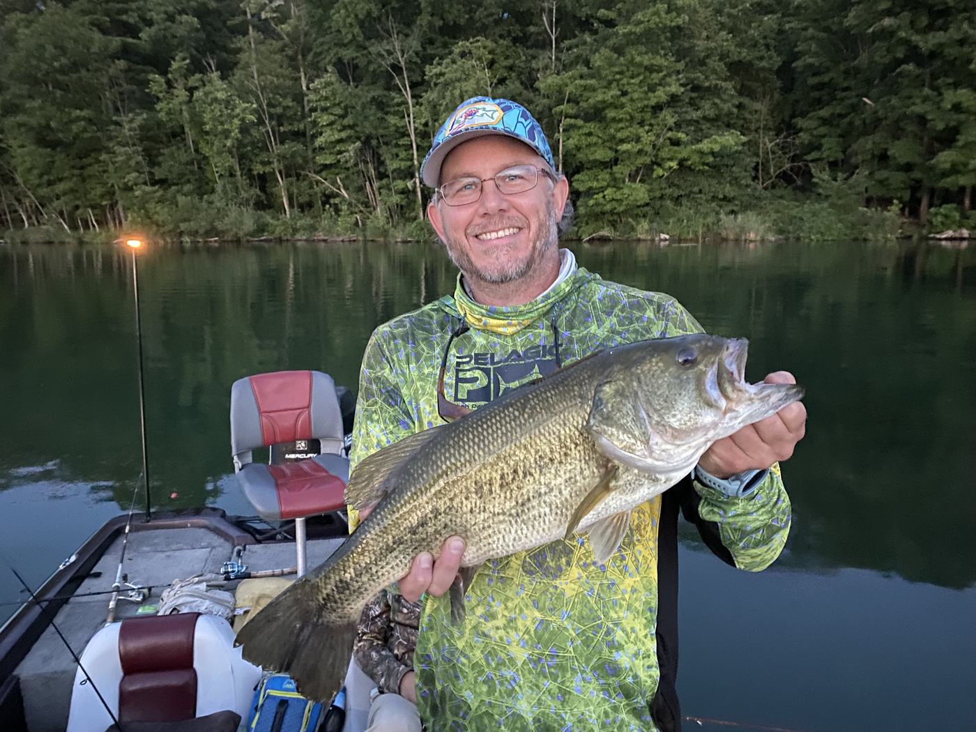 A heavy largemouth bass held up in the last of the evening light.