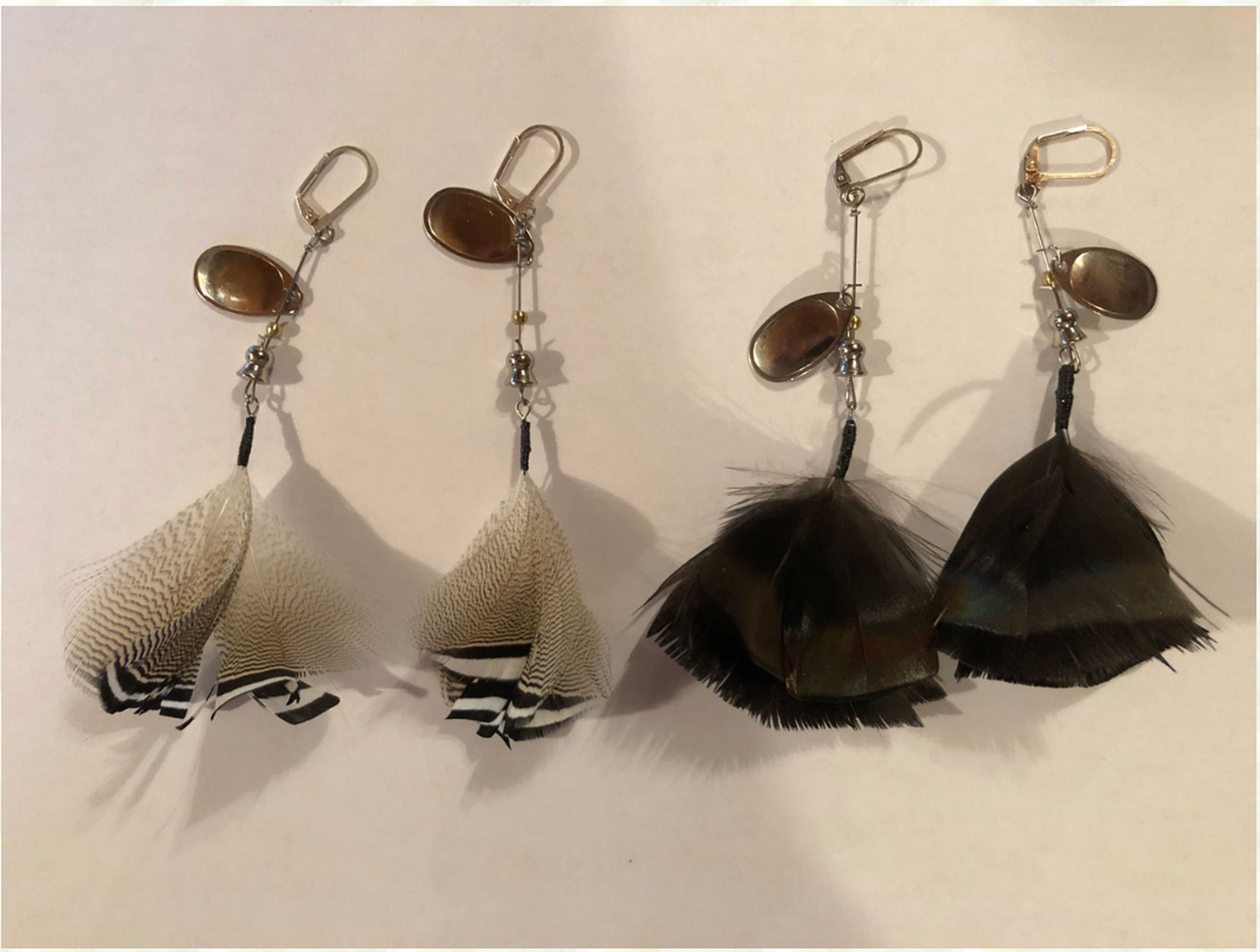 Handmade wood duck and turkey feather earrings by Timberwolf Spinners.