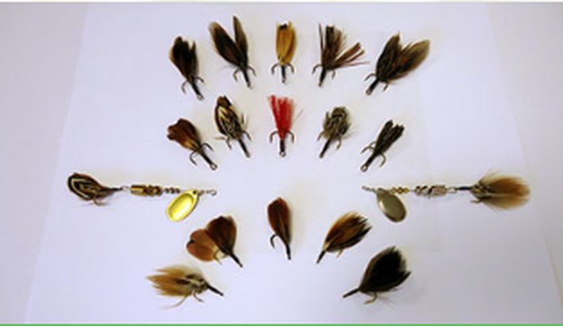 Dozens of hand-tied Timberwolf tails arranged around two finished spinners.