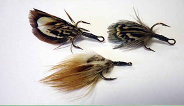 Two Timberwolf spinners with long natural feather tails.